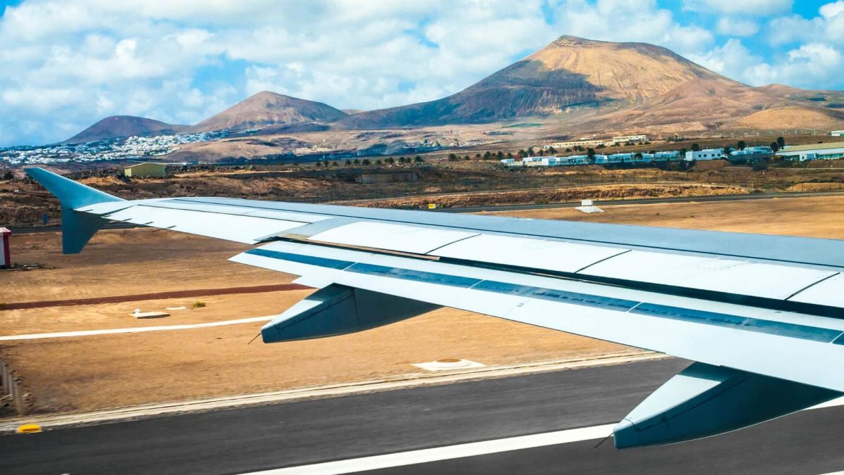 plane landing at lanzarote airport with view of landscape